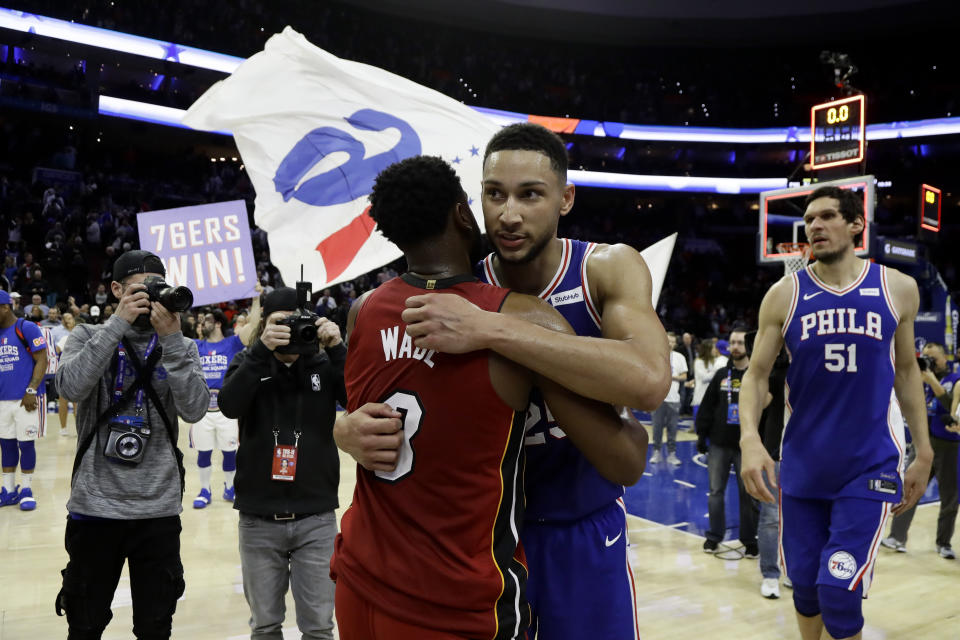 Miami Heat's Dwyane Wade, left, and Philadelphia 76ers' Ben Simmons meet after an NBA basketball game Thursday, Feb. 21, 2019, in Philadelphia. Philadelphia won 106-102. (AP Photo/Matt Slocum)