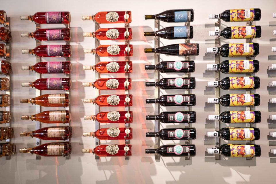 A selection of Arizona wines hangs on the walls of the Wine Collective in Scottsdale on June 16, 2022.