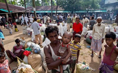 Newly arrived Rohingya Muslims from Myanmar prepare to leave a transit shelter in Shahparirdwip, Bangladesh - Credit: AP