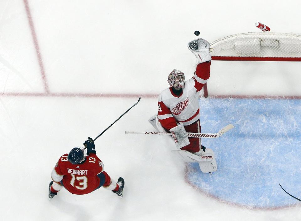 1933431094.jpg SUNRISE, FL - JANUARY 17: Sam Reinhart #13 of the Florida Panthers skates in on goal as goaltender Alex Lyon #34 of the Detroit Red Wings reaches up to defend the net at the Amerant Bank Arena on January 17, 2024 in Sunrise, Florida. (Photo by Joel Auerbach/Getty Images)