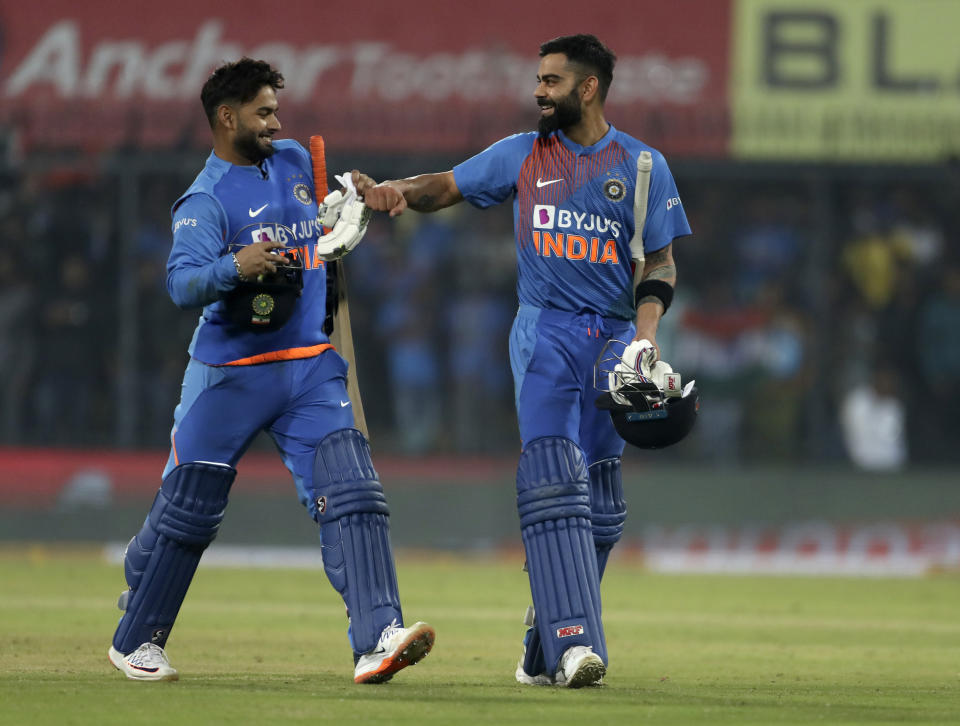 India's captain Virat Kohli, right, and teammate Rishabh Pant celebrate their win in the second Twenty20 international cricket match between India and Sri Lanka in Indore, India, Tuesday, Jan. 7, 2020. India won the match by seven wickets. (AP Photo/Aijaz Rahi)