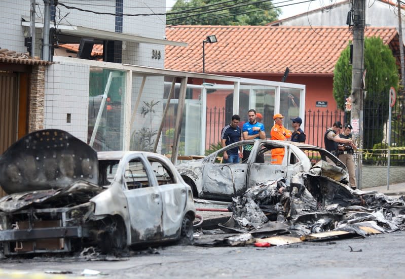 Wrecked cars are seen at the site where a small plane crashed on a residential street in Belo Horizonte