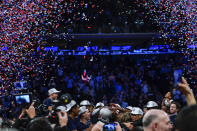 Villanova's Collin Gillespie, center, celebrates with teammates around the tournament trophy after an NCAA college basketball game against Creighton in the final of the Big East conference tournament Saturday, March 12, 2022, in New York. (AP Photo/Frank Franklin II)