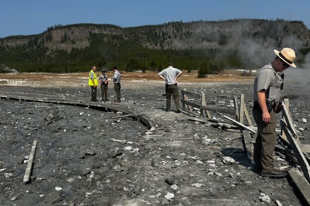 <p>Courtesy of NPS Photo</p> Park staff assess the damage to Biscuit Basin boardwalks after hydrothermal explosion