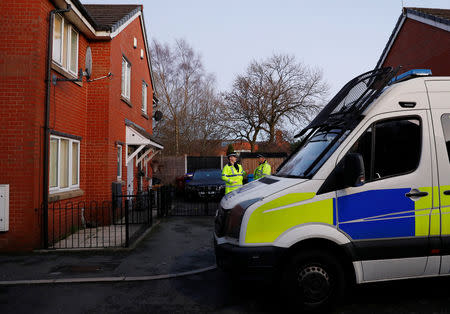 Police officers stand outside a house being searched in connection to a stabbing at Victoria Station in Manchester, Britain, January 1, 2019. REUTERS/Phil Noble