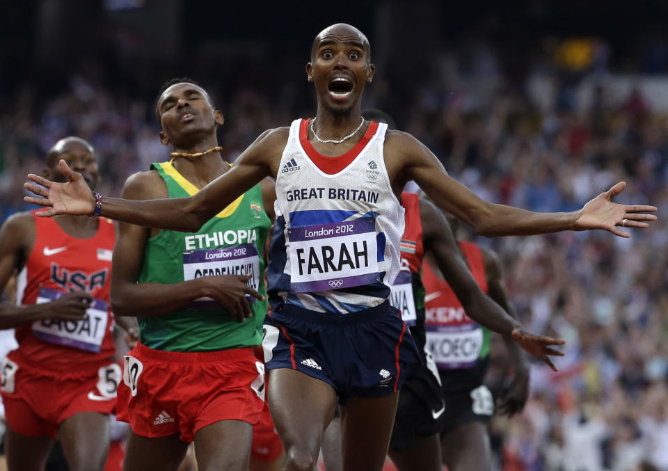FILE - Britain's Mohamed Farah celebrates as he crosses the finish line to win the men's 5000-meter final during the athletics in the Olympic Stadium at the 2012 Summer Olympics, London, Saturday, Aug. 11, 2012. (AP Photo/Anja Niedringhaus, File)