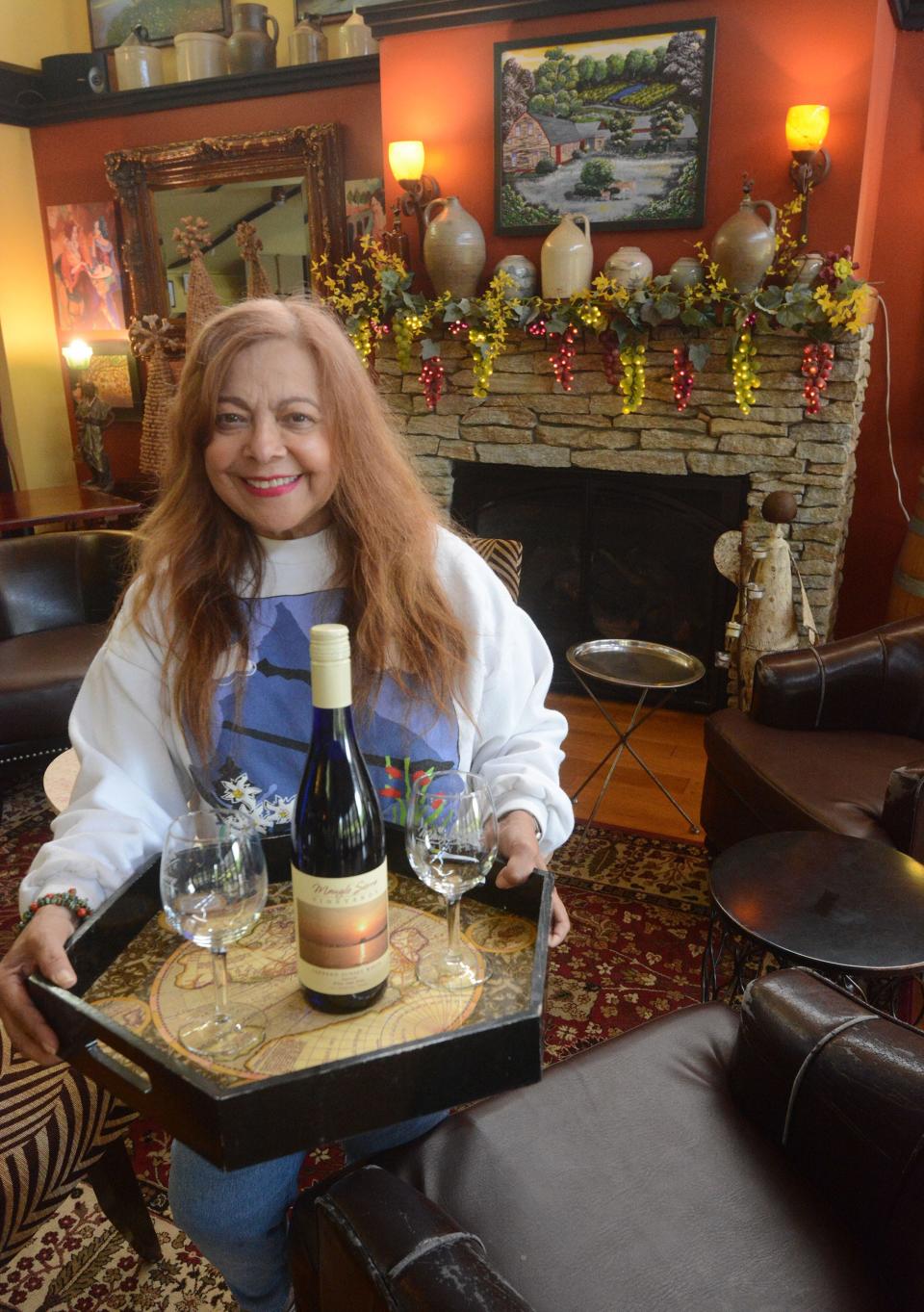 Betty Maugle, co-owner of Maugle Sierra Vineyards & Winery, with some of their wine in the tasting room at the 130 acre vineyard that has 11 1/2 acres of vineyards. File photo