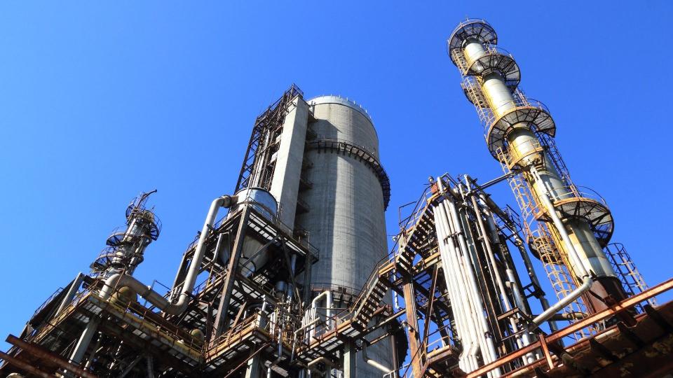 Eine industrielle Fabrik aus der Froschperspektive vor blauem Himmel