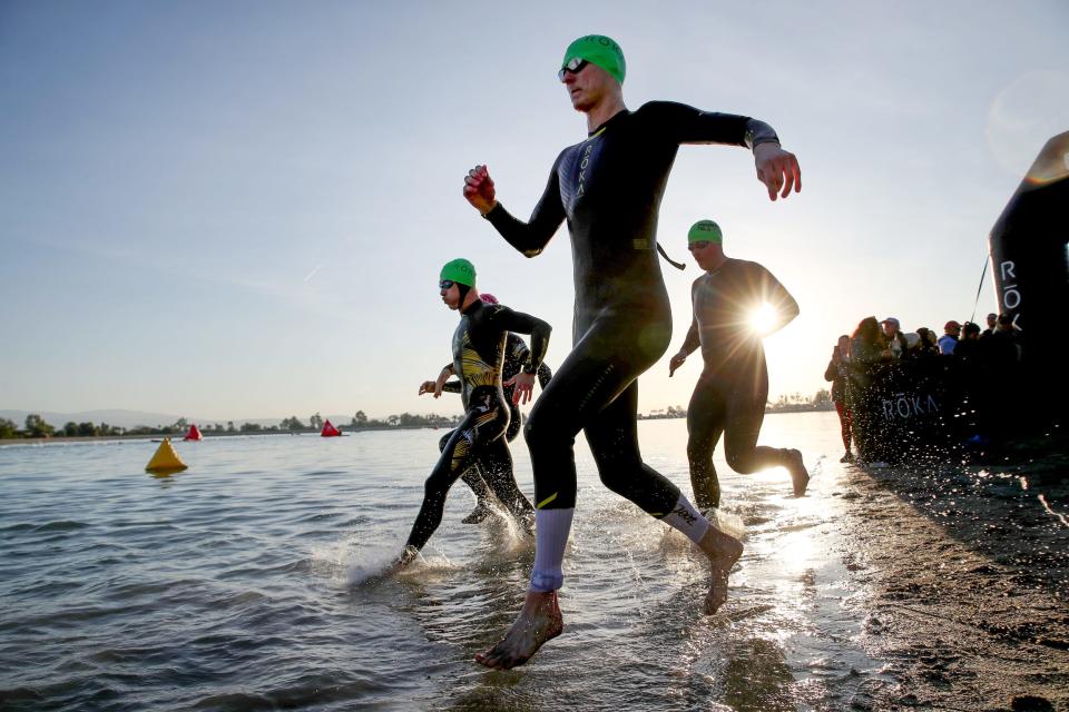 Triathletes begin the swim portion to kick off the fifth Ironman 70.3 Indian Wells at Lake Cahuilla in La Quinta, Calif.