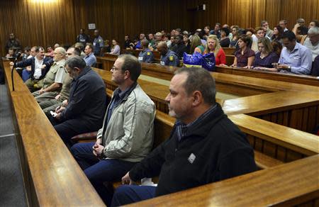 Members of the right-wing "Boeremag" wait ahead of their sentencing at Pretoria High Court October 29, 2013. The mastermind of a "Boer Army" white supremacist plot to assassinate Nelson Mandela and drive blacks out of South Africa was sentenced to 35 years in prison on Tuesday after a trial lasting more than 10 years, state media said. Former university lecturer Mike du Toit was convicted of high treason for his leadership role in the "Boeremag", a rag-tag militia of apartheid loyalists accused of a botched 2002 coup attempt in Africa's biggest economy that aimed to overthrow the ruling African National Congress.REUTERS/Stringer