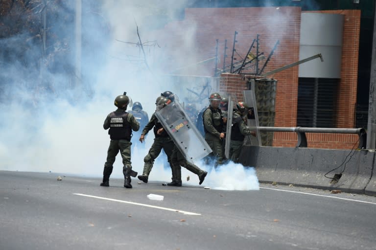 Riot police clash with demonstrators protesting against Venezuelan President Nicolas Maduro's government, in Caracas, on April 10, 2017