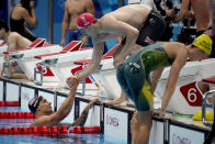 Caeleb Dressel, of the United States, left, talks with Britain's James Guy after the mixed 4x100-meter medley relay at the 2020 Summer Olympics, Saturday, July 31, 2021, in Tokyo, Japan. (AP Photo/David Goldman)