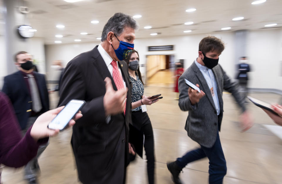 Sen. Joe Manchin (D-W.Va.) speaks with reporters in the Senate subway as he arrives for a vote in the Capitol on Wednesday, March 24. (Photo: Bill Clark via Getty Images)