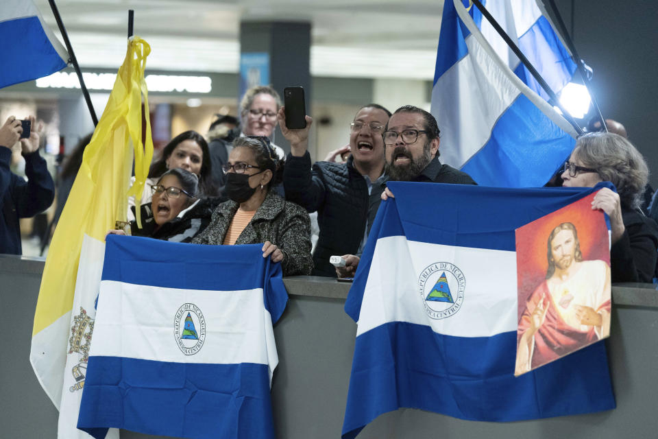 Supporters of Nicaraguan political prisoners chant at Washington Dulles International Airport, in Chantilly, Va., on Thursday, Feb. 9, 2023. Some 222 inmates considered by many to be political prisoners of the government of Nicaraguan President Daniel Ortega arrived at Washington after an apparently negotiated release. (AP Photo/Jose Luis Magana)