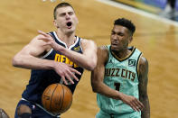 Denver Nuggets center Nikola Jokic, left, is fouled by Charlotte Hornets guard Malik Monk during the first half of an NBA basketball game on Tuesday, May 11, 2021, in Charlotte, N.C. (AP Photo/Chris Carlson)