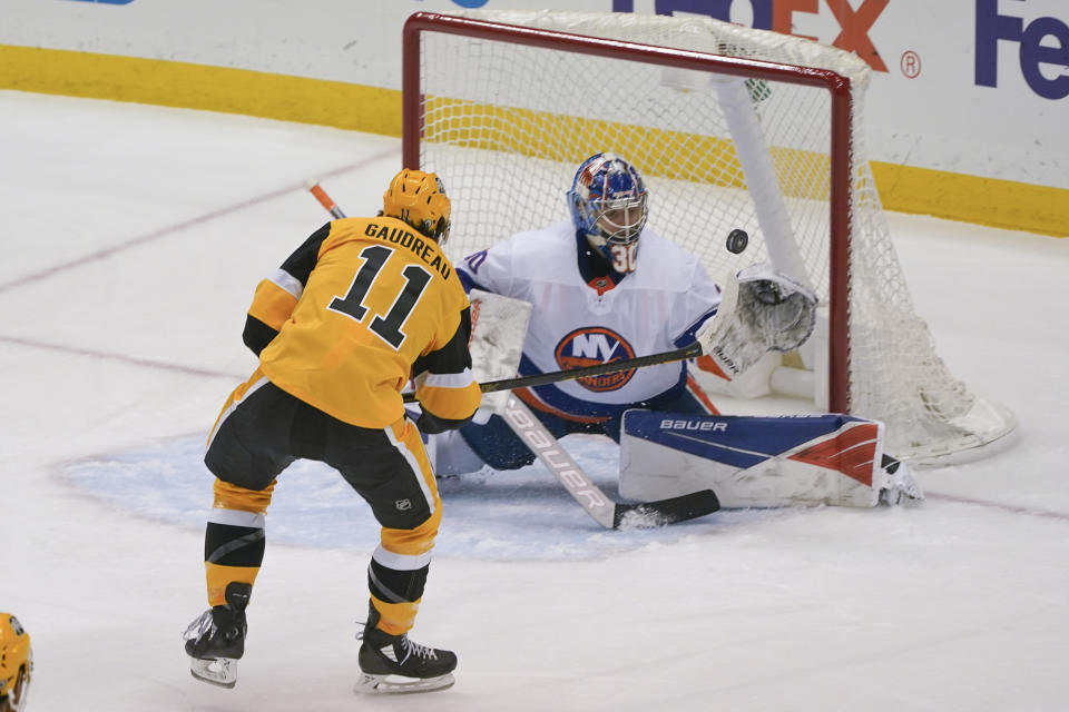 Pittsburgh Penguins' Frederick Gaudreau (11) scores over New York Islanders goaltender Ilya Sorokin (30) during the first period of an NHL hockey game Saturday, March 27, 2021, in Pittsburgh. (AP Photo/Keith Srakocic)