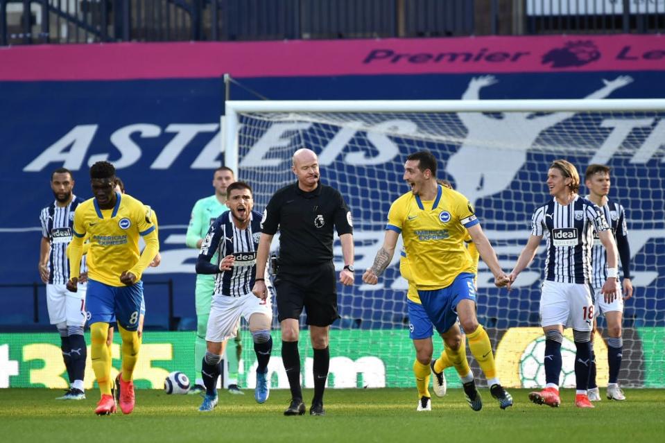 Lewis Dunk celebrates after a quickly taken free kick before the goal is disallowed following a VAR reviewGetty