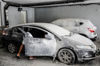 FILE PHOTO: An Israeli man checks his car at the parking area under a residential building in Ashkelon, Israel, which was damaged by a rocket launched overnight from the Gaza Strip