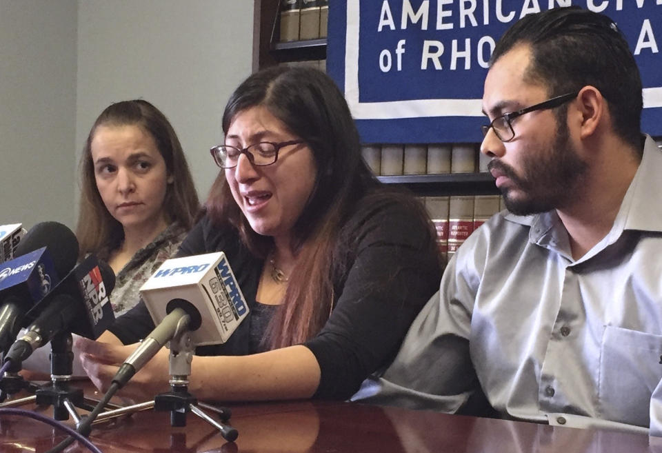 FILE - In this Feb. 14, 2018, file photo, Lilian Calderon, center, cries as she describes her experiences while in custody, alongside her husband, Luis Gordillo, right, during a news conference at the office of the American Civil Liberties Union in Providence, R.I. Gordillo is a U.S. citizen, but Calderon is a native of Guatemala who came to the country with her family at the age of 3. She was ordered to leave in 2002 after her father was denied asylum. (AP Photo/Michelle R. Smith, File)