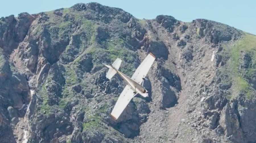 A Cessna plane nose down in the Colorado Rocky Mountains