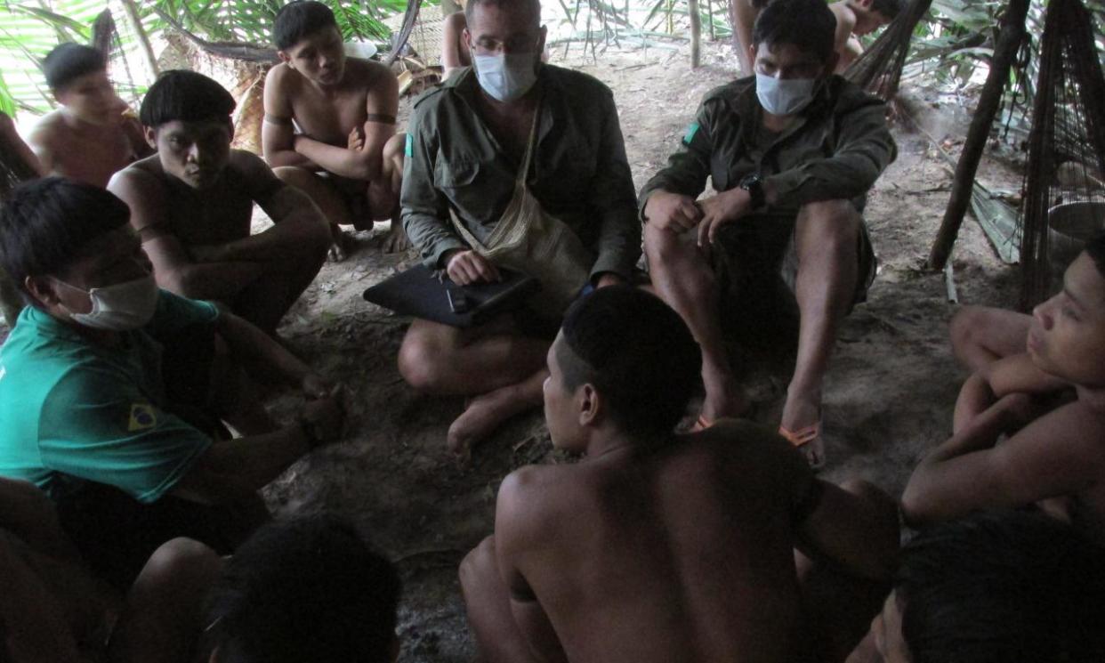 <span>Beto Marubo and Bruno Pereira speaking with the Indigenous peoples of the Korubo tribe in the Javari valley, in 2015.</span><span>Photograph: Courtesy of Beto Marubo</span>