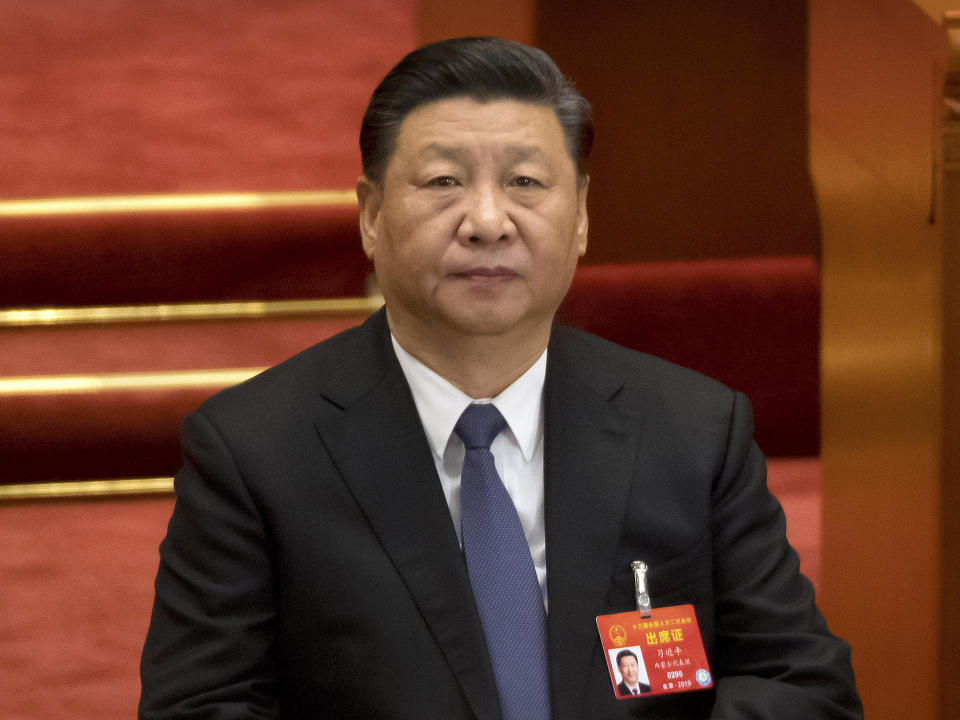 FILE - In this March 12, 2019, file photo, Chinese President Xi Jinping attends a plenary session of China's National People's Congress (NPC) at the Great Hall of the People in Beijing. Two former Philippine officials are filing a complaint with the International Criminal Court accusing Chinese President Xi of crimes against humanity over his government's assertive actions in the South China Sea. (AP Photo/Mark Schiefelbein, File)