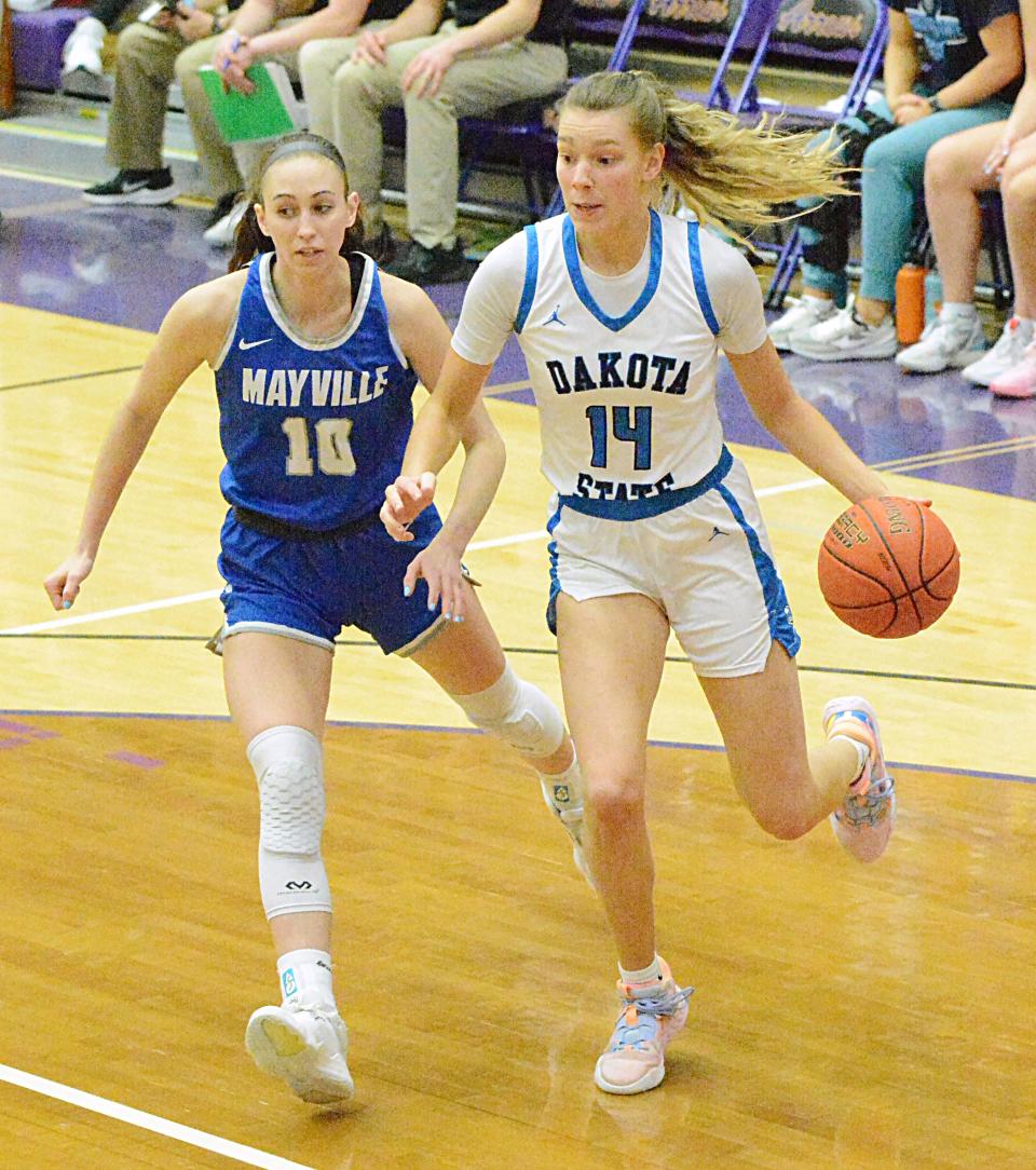 Dakota State's Savannah Walsdorf (14) drives against Mayville State's Jes Mertens during the women's championship game of the North Star Athletic Association Basketball Final Four on Sunday, Feb. 26, 2023 in the Watertown Civic Arena.