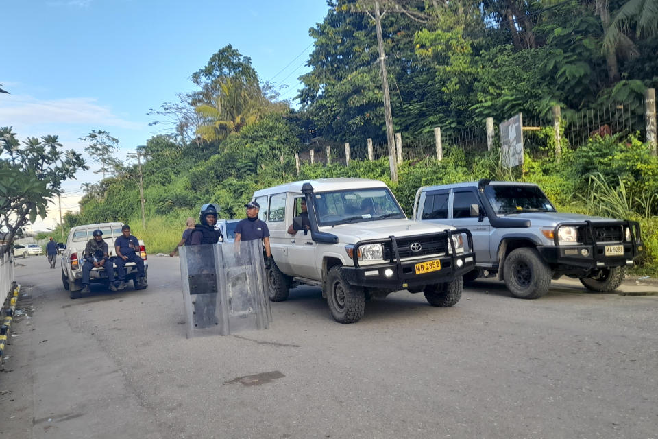 Police man a road block in Honiara, Solomon Islands, Friday, Nov. 26, 2021. Violence receded in the capital of the Solomon Islands, but the government showed no signs of attempting to address the underlying grievances that sparked two days of riots, including concerns of the country's increasing links with China (AP Photo/Piringi Charley)