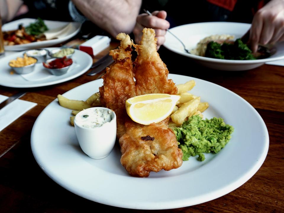 Fish and chips on a plate at a pub