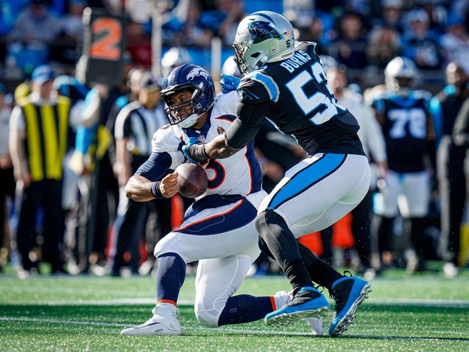 Russell Wilson is sacked by the Carolina Panthers defense.