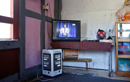 An electric heater and television sit in the corner of a traditional farmhouse in Punakha, Bhutan, December 13, 2017. REUTERS/Cathal McNaughton