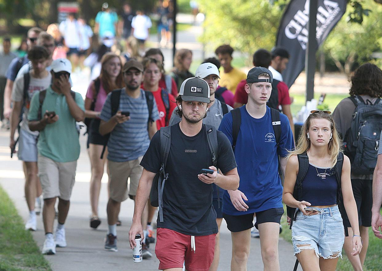 Iowa State University students walk to class on the first day of the new school year Monday, Aug. 21, 2023, in Ames, Iowa.