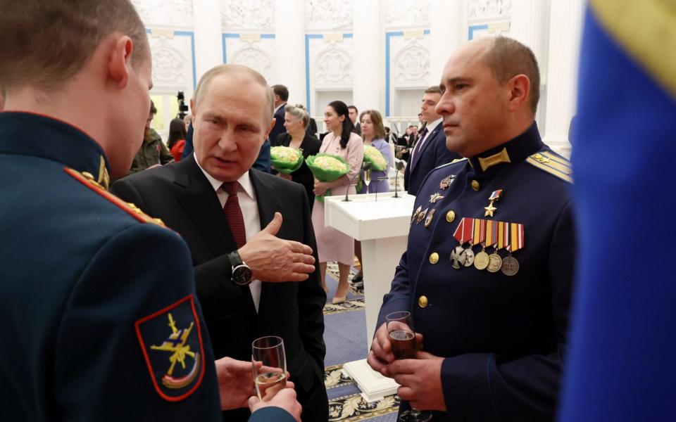 Russian President Vladimir Putin (C) speaks with Senior Lieutenant Stepan Belov and Major Konstantin Shirokov - VALERY SHARIFULIN/KREMLIN/POOL/EPA-EFE/Shutterstock