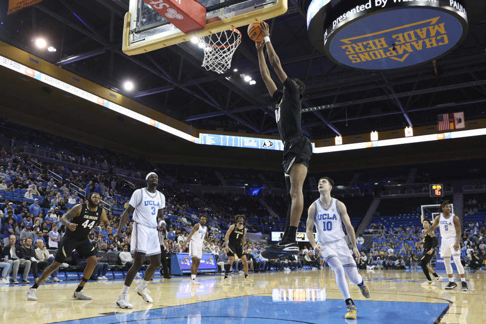 Colorado forward Cody Williams, center top, goes up for a dunk past UCLA guard Lazar Stefanovic (10) during the first half of an NCAA college basketball game Thursday, Feb. 15, 2024, in Los Angeles. (AP Photo/Raul Romero Jr.)