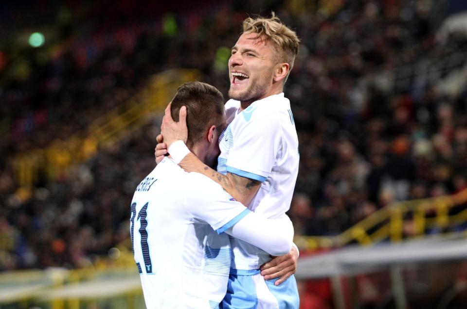 Lazio's Ciro Immobile, right, celebrates after scoring during a Serie A soccer match between Bologna and Lazio, at the Dall'Ara stadium in Bologna, Italy, Sunday, March 5, 2017. (Giorgio Benvenuti/ANSA via AP)