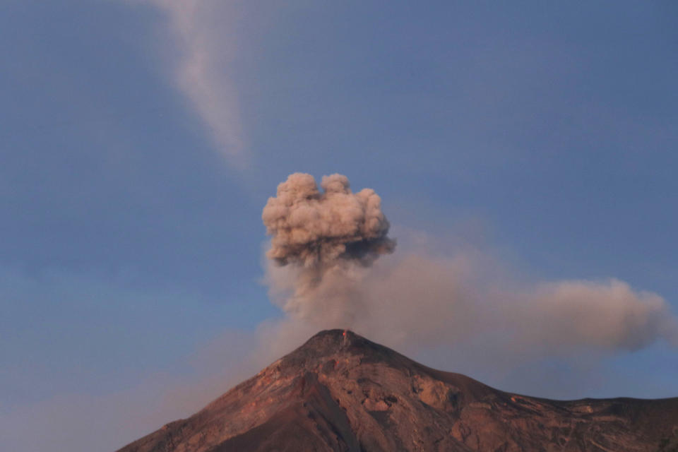 The Volcan de Fuego, or Volcano of Fire, spews a plume of ash as seen from San Juan Alotenango, Guatemala, Tuesday, Nov. 20, 2018. The volcanology institute reported that activity subsided Monday evening. Hundreds of families who heeded the call of disaster coordination authorities to evacuate 10 communities began returning to their homes Tuesday. (AP Photo/Moises Castillo)