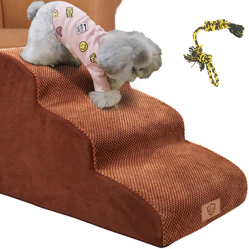 Photo of a dog walking down from a sofa on Topmart 3 Tiers Foam Dog Ramps/Steps