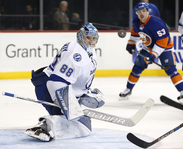 New York Islanders' center Casey Cizikas (53) watches as Tampa Bay Lightning goalie Andrei Vasilevskiy (88) of Russia keeps his eye on the puck as it sails past him after he made a save on goal during the second period of an NHL hockey game, Monday, Nov. 14, 2016, in New York. (AP Photo/Kathy Willens)