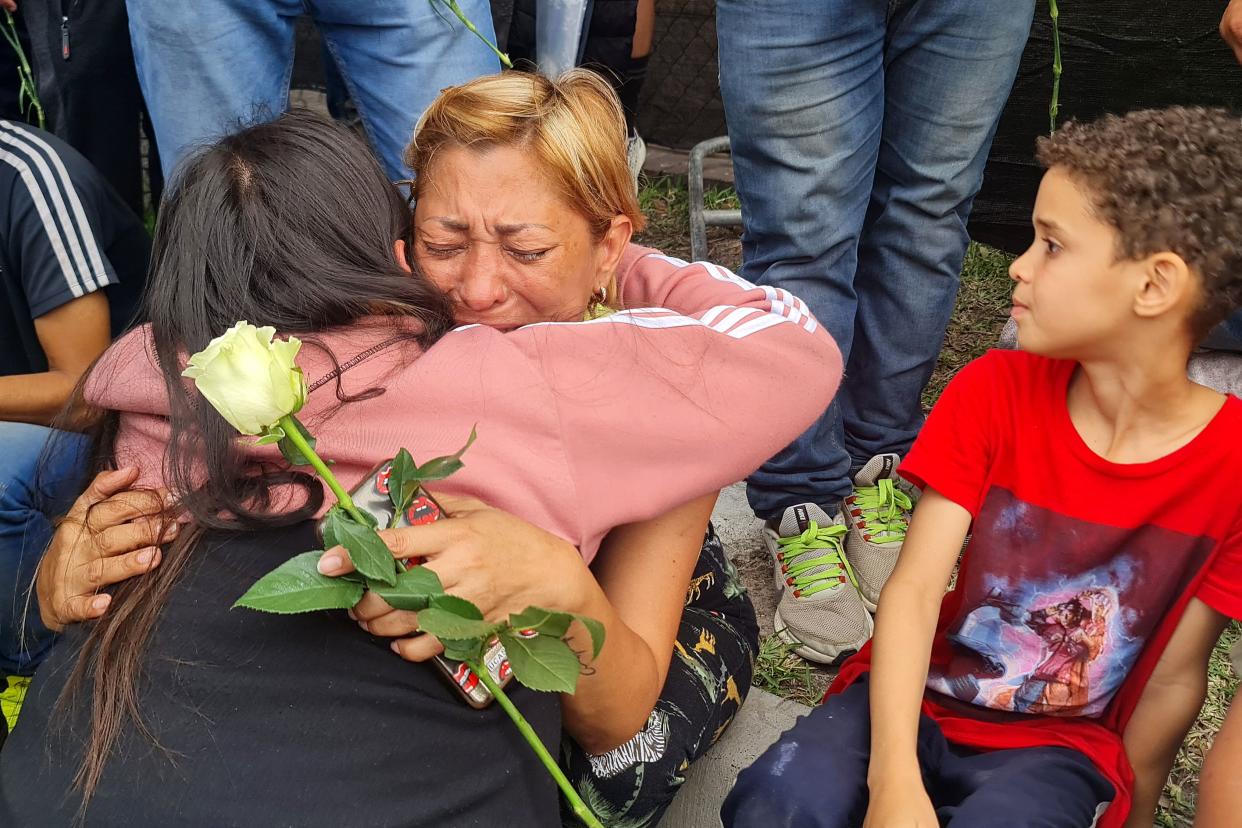 Venezuelan migrants mourn as they gather near The Plaza Bus Station, in Brownsville, Texas on 8 May 2023, a day after an SUV plowed into a crowd and killed eight (AFP via Getty Images)