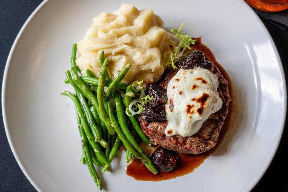 Filet Pierpont, topped with blue cheese cream and malted figs, comes with roasted garlic whipped potatoes and baby green beans at Pierpont’s in Union Station.