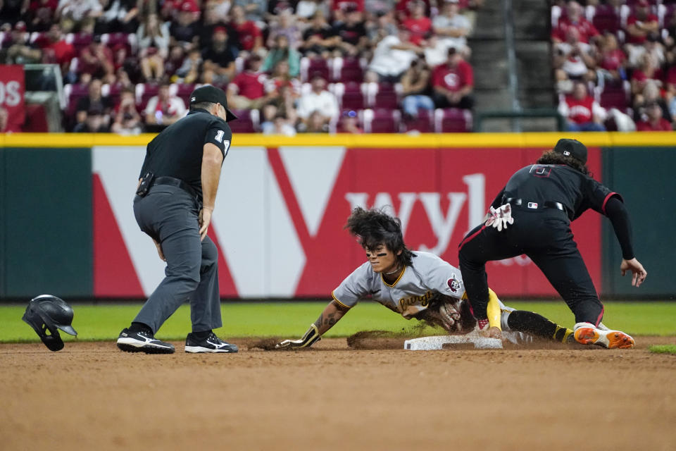 Pittsburgh Pirates' Ji Hwan Bae, center, steals second base as Cincinnati Reds second baseman Jonathan India, right, attempts a tag during the seventh inning of a baseball game, Friday, Sept. 22, 2023, in Cincinnati. (AP Photo/Joshua A. Bickel)