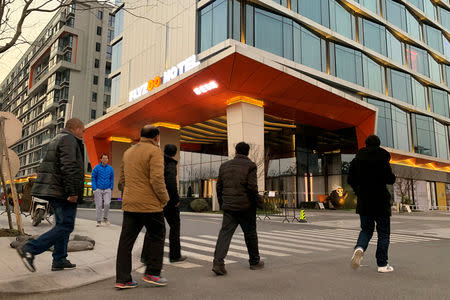 Men walk past Alibaba Group's futuristic FlyZoo hotel in Hangzhou, Zhejiang province, China January 22, 2019. REUTERS/Xihao Jiang
