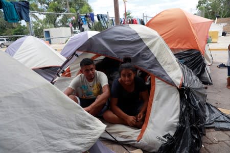 Honduran migrants Marvin Madrid and his new wife Dexy Maldonado speak during an interview with Reuters in an encampment in Matamoros