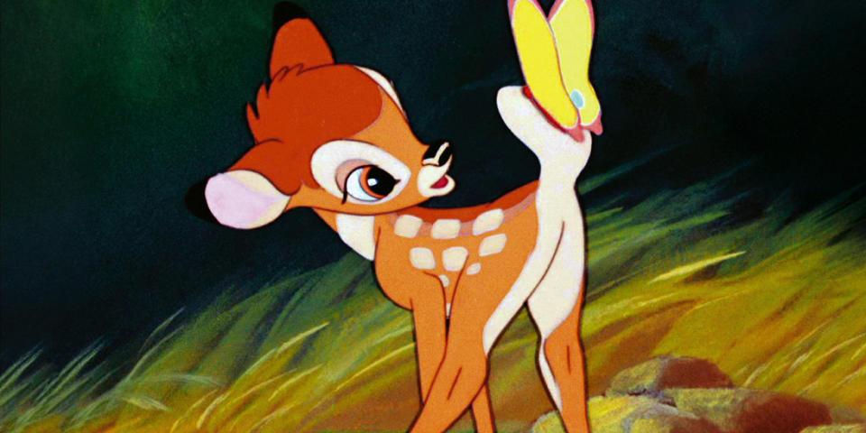 Bambi looks at a yellow butterfly on its tail
