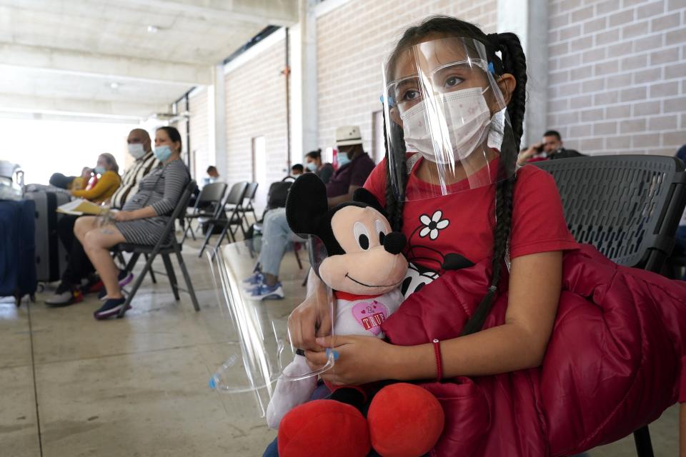 Genesis Cuellar, 8, a migrant from El Salvador, sits in a waiting area to be processed by Team Brownsville, a humanitarian group, helping migrants released from U.S. Customs and Border Protection custody, in March 2021, in Brownsville, Texas.