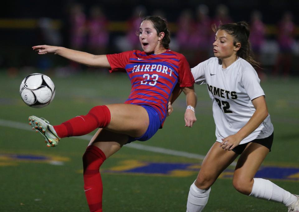 Fairport's Andrea Wilson sends the ball upfield as Rush-Henrietta's Ava Santiago defends in their Section V Class AAA championship final.