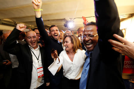 Supporters of French President-elect Emmanuel Macron, head of the political movement En Marche !, or Onwards !, react after announcement in the second round of 2017 French presidential election at En Marche local headquarters in Marseille, France, May 7, 2017. REUTERS/Philippe Laurenson