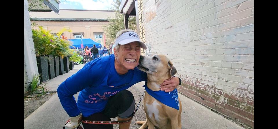 DeLand resident Debra Cole gets a kiss from Red, her now 10.5-year-old dog who was diagnosed with cancer in January 2020 and estimated to have six to 12 months to live. The two participated in the return of the ME STRONG 5K on Saturday, Feb. 4, 2023, in downtown DeLand.