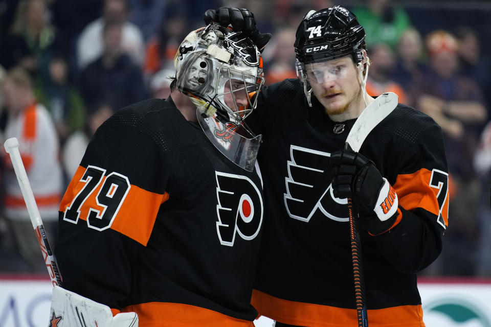 Philadelphia Flyers' Owen Tippett, right, and Carter Hart celebrate after an NHL hockey game against the Buffalo Sabres, Friday, March 17, 2023, in Philadelphia. (AP Photo/Matt Slocum)