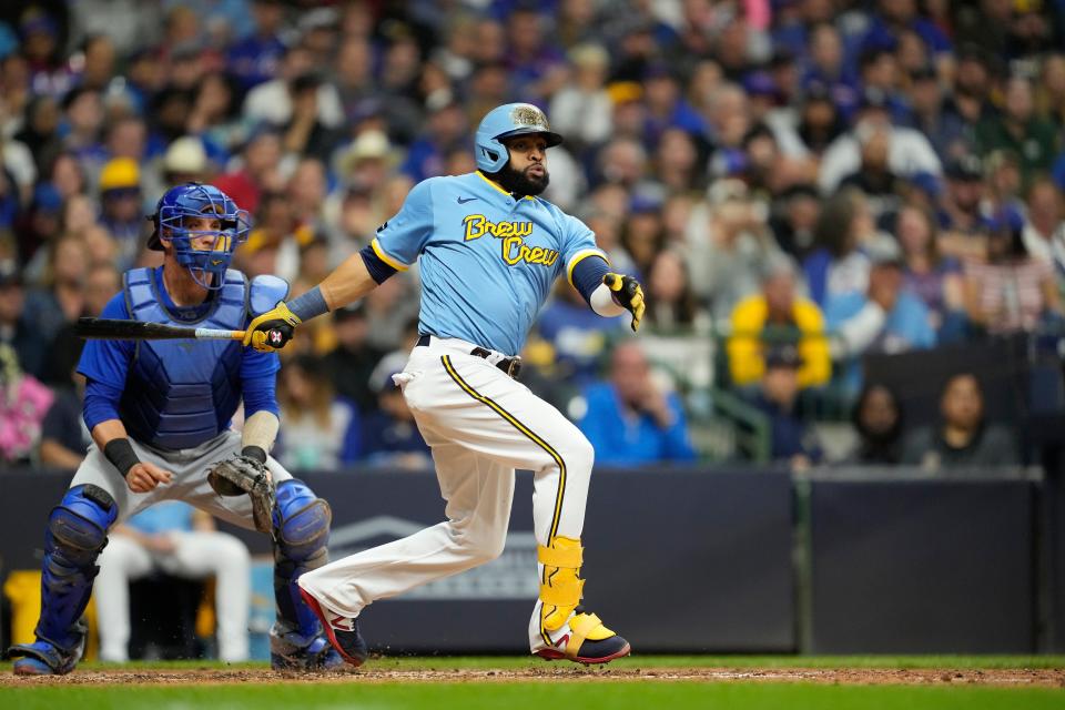 Carlos Santana of the Milwaukee Brewers hits an RBI triple against the Chicago Cubs in the fifth inning at American Family Field.